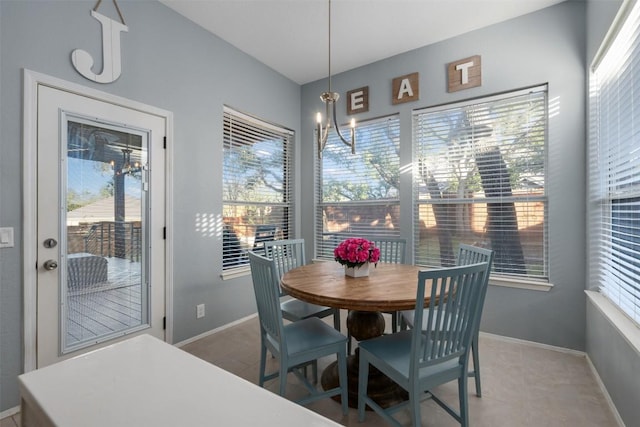 tiled dining space with a wealth of natural light and a chandelier