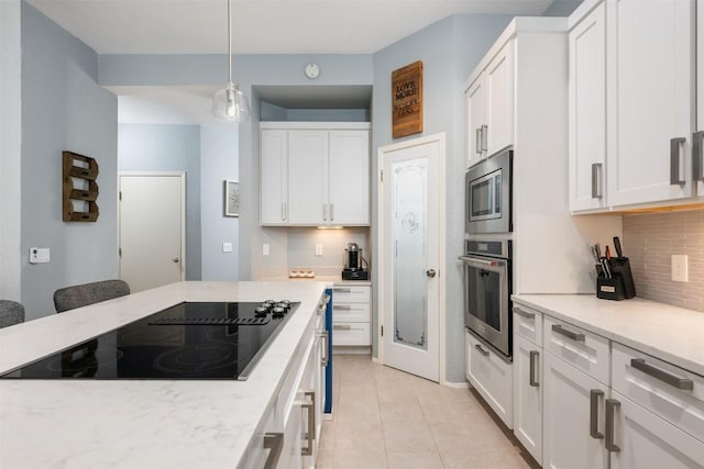 kitchen featuring white cabinetry, light tile patterned flooring, stainless steel microwave, black electric cooktop, and backsplash