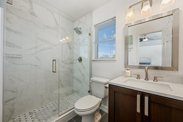 bathroom with ceiling fan, a shower with door, vanity, and toilet