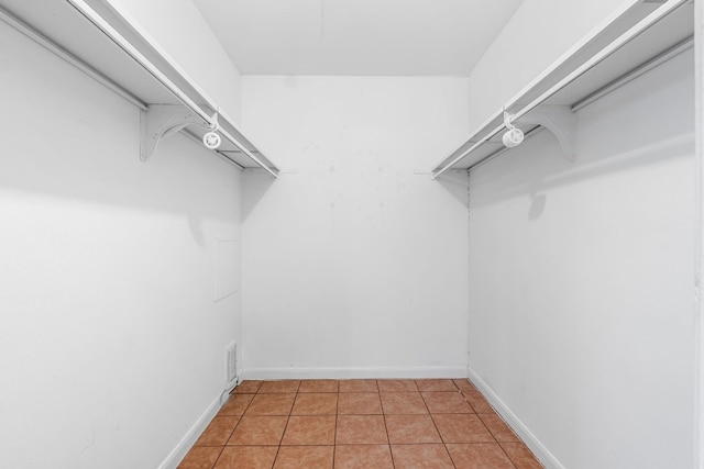 walk in closet with tile patterned floors