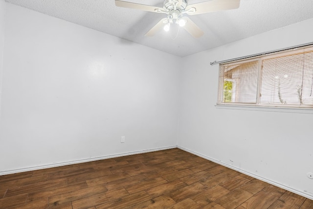 empty room featuring a textured ceiling, ceiling fan, and dark hardwood / wood-style floors