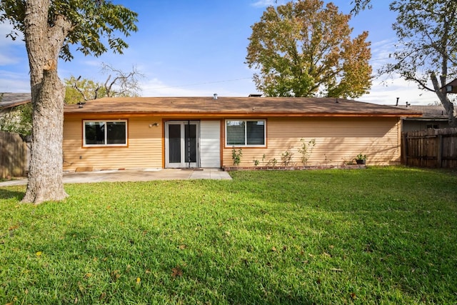 rear view of house featuring a yard and a patio