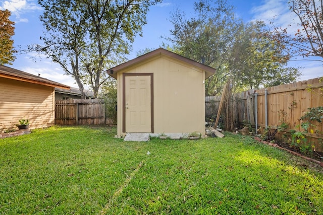 view of outbuilding with a yard