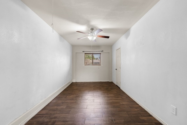 unfurnished room with ceiling fan and dark wood-type flooring