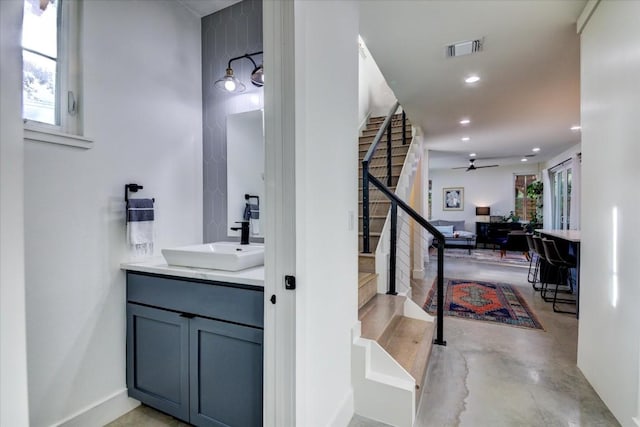 bathroom with concrete flooring, vanity, and ceiling fan