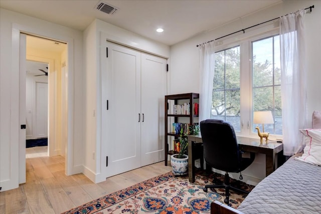 bedroom with a closet and light hardwood / wood-style flooring