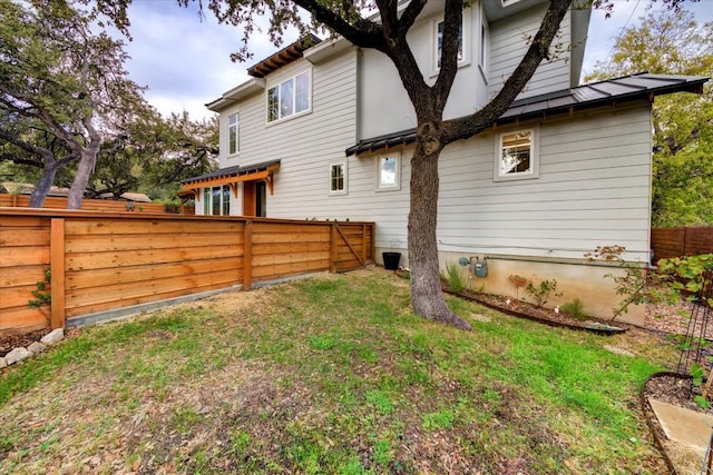 rear view of house featuring a lawn