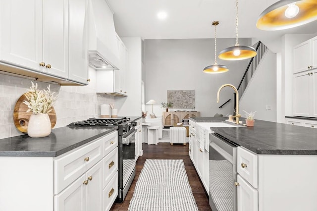 kitchen featuring high end range, dark hardwood / wood-style flooring, premium range hood, decorative light fixtures, and white cabinetry