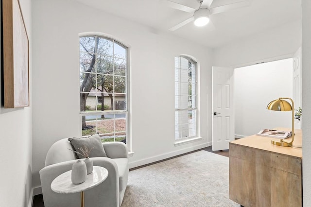 sitting room featuring hardwood / wood-style floors and ceiling fan