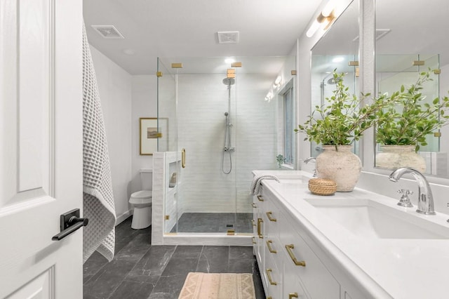 bathroom with vanity, a shower with shower door, and toilet