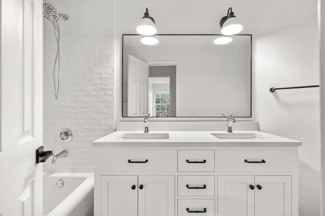 bathroom with vanity and tiled shower / bath combo