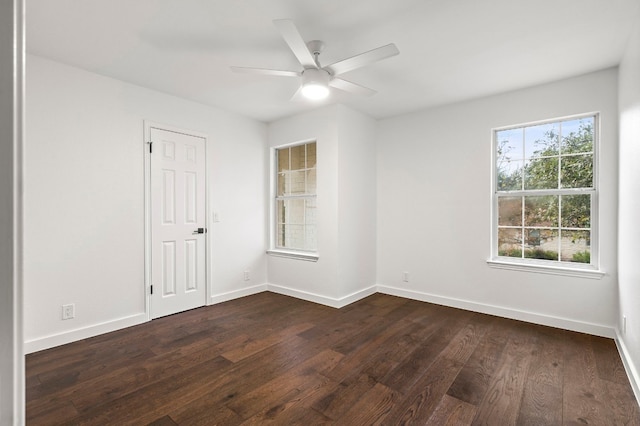 empty room with ceiling fan and dark wood-type flooring