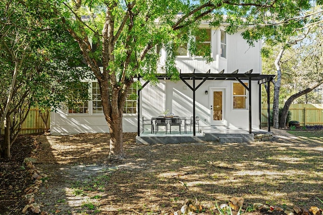 back of house featuring a pergola