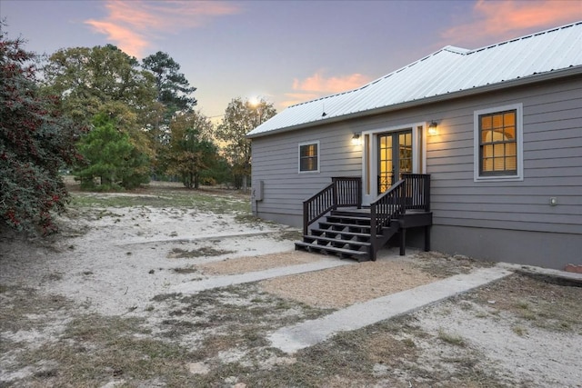 rear view of house featuring metal roof and french doors