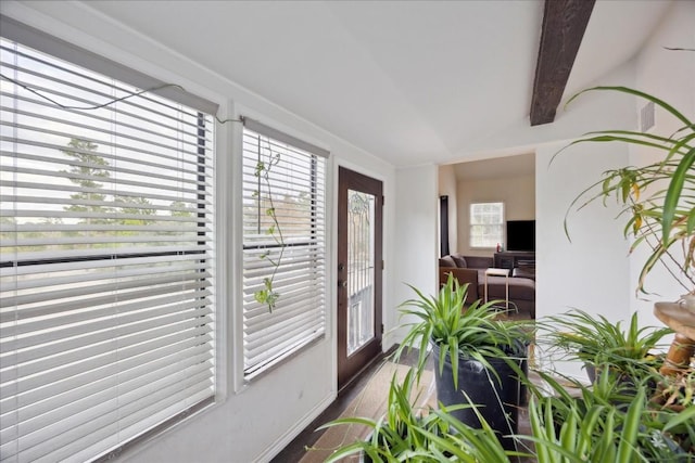 sunroom featuring beamed ceiling