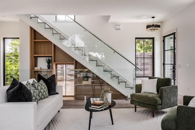 living room with a notable chandelier and wood-type flooring