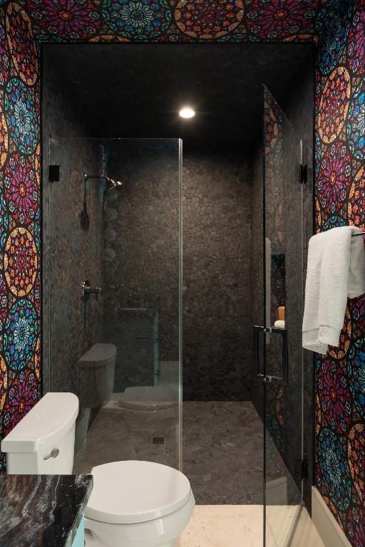 bathroom with toilet and an enclosed shower