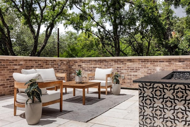 view of patio / terrace featuring an outdoor living space with a fire pit