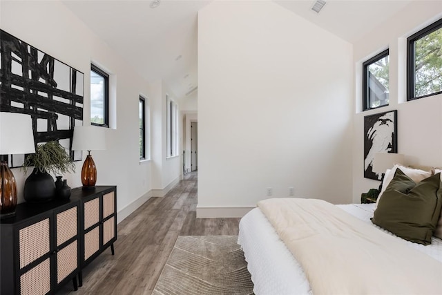 bedroom featuring wood-type flooring and lofted ceiling