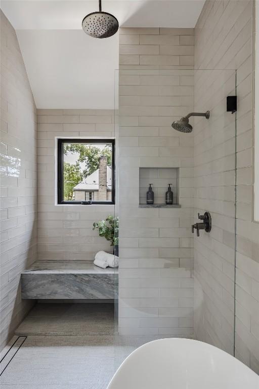 bathroom featuring lofted ceiling and shower with separate bathtub