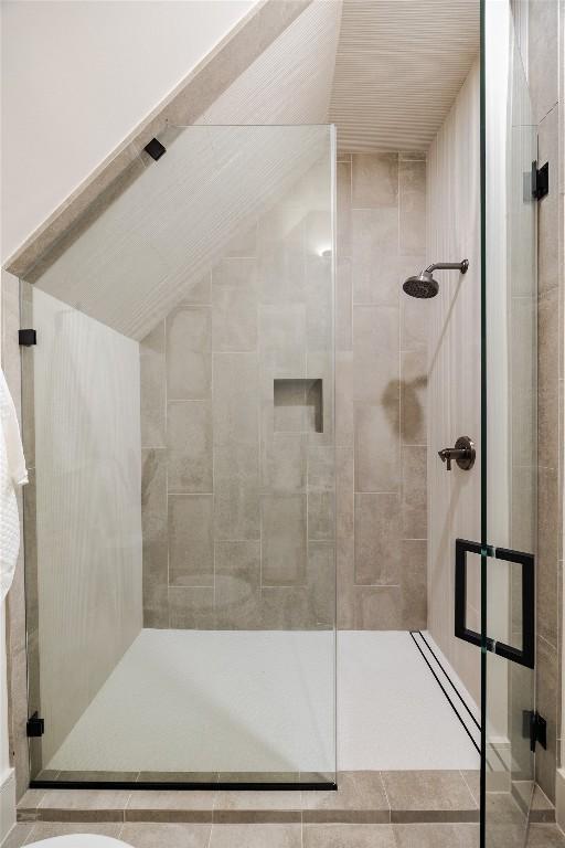 bathroom featuring a shower with door