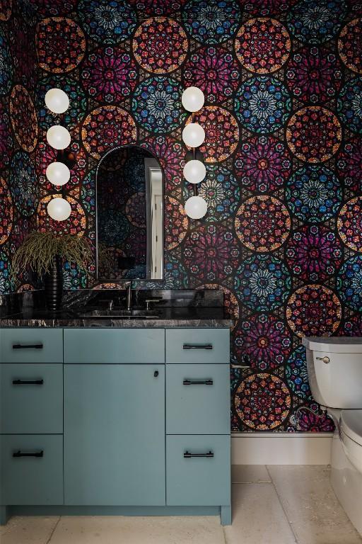 bathroom featuring tile patterned flooring, vanity, and toilet