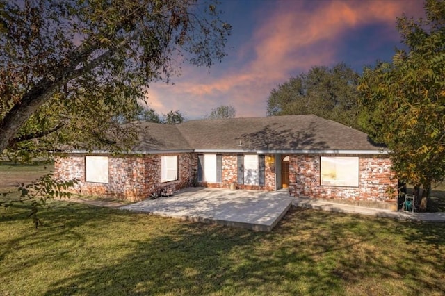 view of front facade with a patio area and a lawn