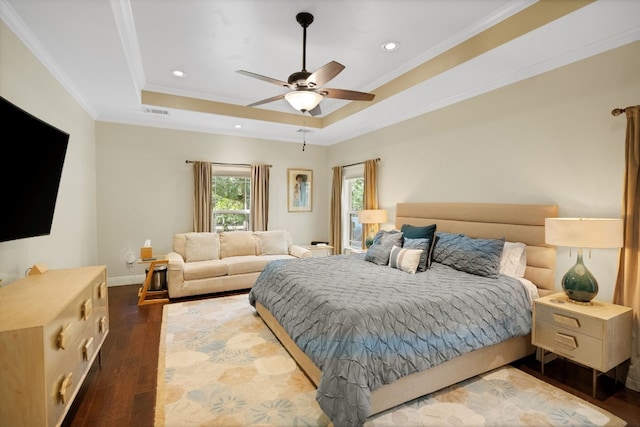 bedroom with a raised ceiling, ceiling fan, dark hardwood / wood-style flooring, and crown molding