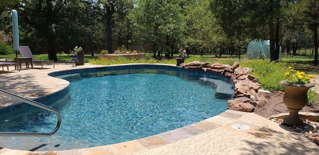 view of swimming pool with a patio area