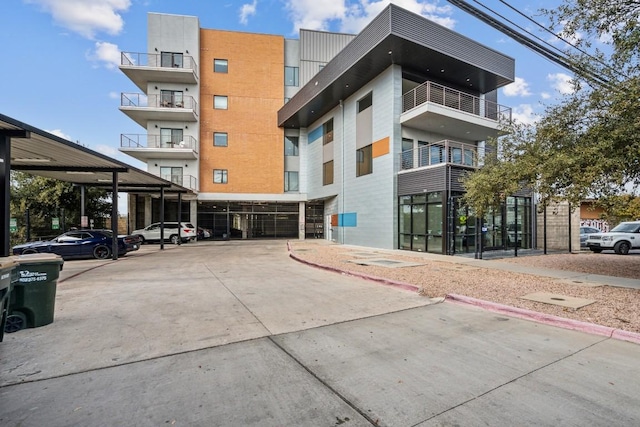 6444 Burnet Rd Unit 305, Austin, TX 78757 - view of property featuring covered parking