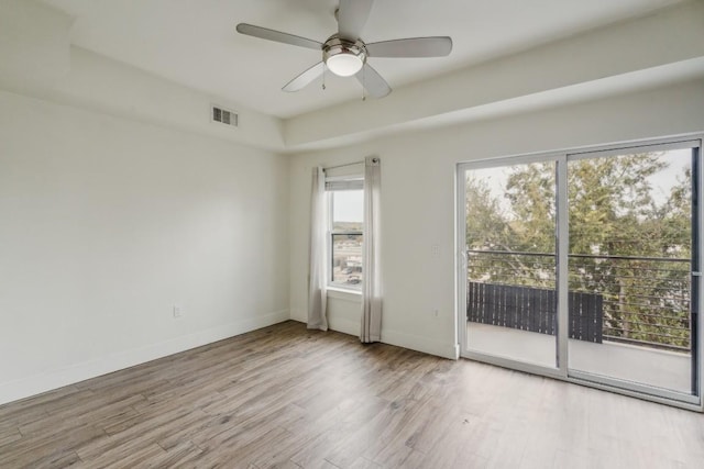 6444 Burnet Rd Unit 305, Austin, TX 78757 - unfurnished room with wood finished floors, a ceiling fan, and baseboards