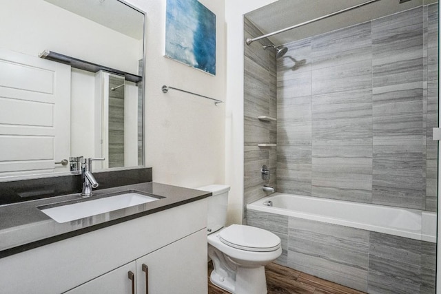 6444 Burnet Rd Unit 305, Austin, TX 78757 - full bathroom featuring toilet, tiled shower / bath, vanity, and wood finished floors