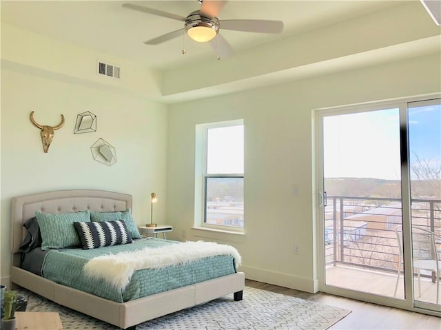 bedroom featuring access to exterior, ceiling fan, and light hardwood / wood-style flooring