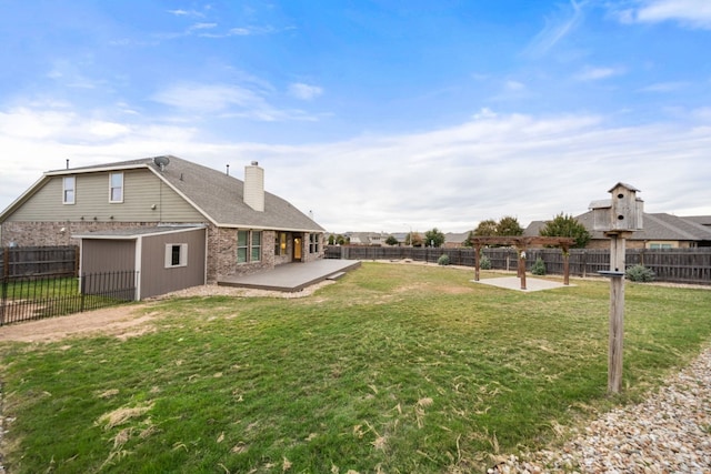 view of yard with a patio area and a storage unit