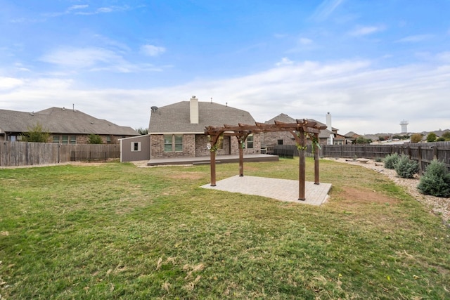 back of property with a lawn, a pergola, and a patio