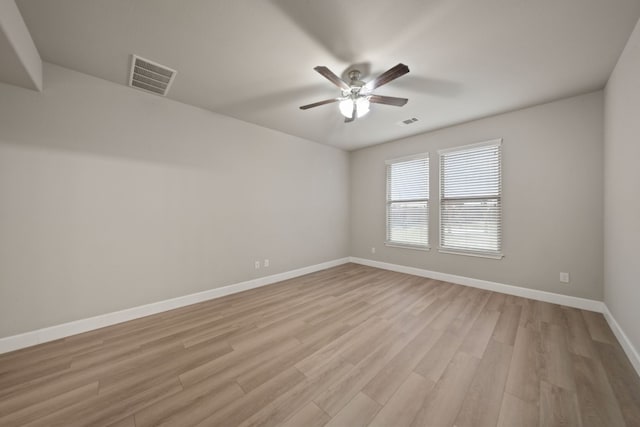 empty room with ceiling fan and light wood-type flooring