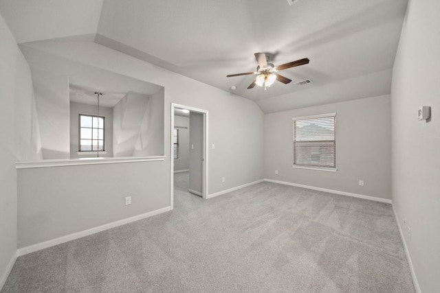 carpeted empty room featuring ceiling fan and lofted ceiling