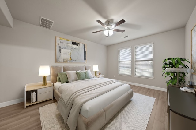 bedroom with light hardwood / wood-style flooring and ceiling fan