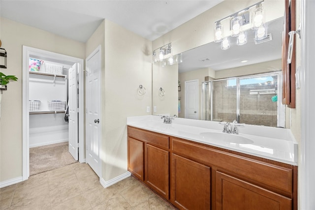 bathroom featuring tile patterned flooring, vanity, and an enclosed shower