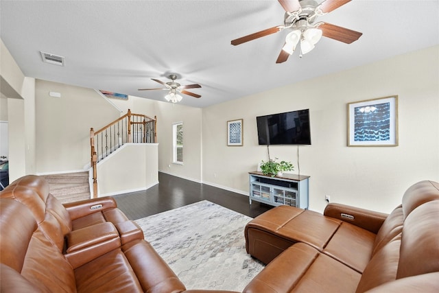 living room featuring a textured ceiling, dark hardwood / wood-style floors, and ceiling fan