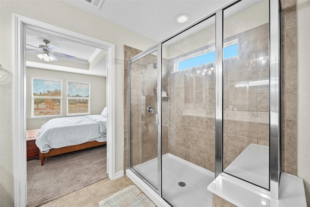 bathroom with tile patterned floors, ceiling fan, and a shower with door