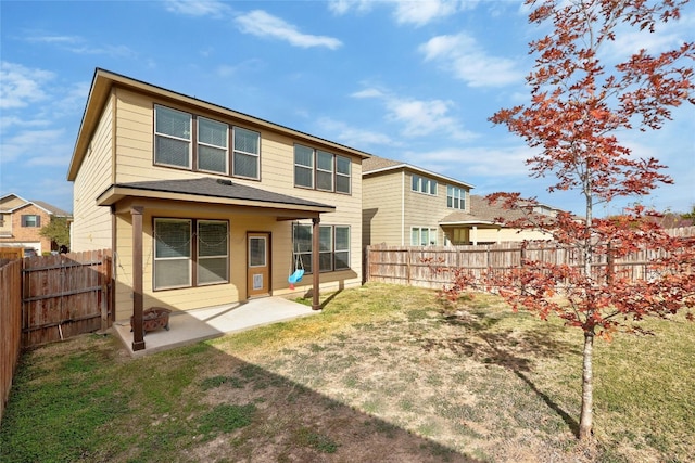 back of property with a lawn and a patio area