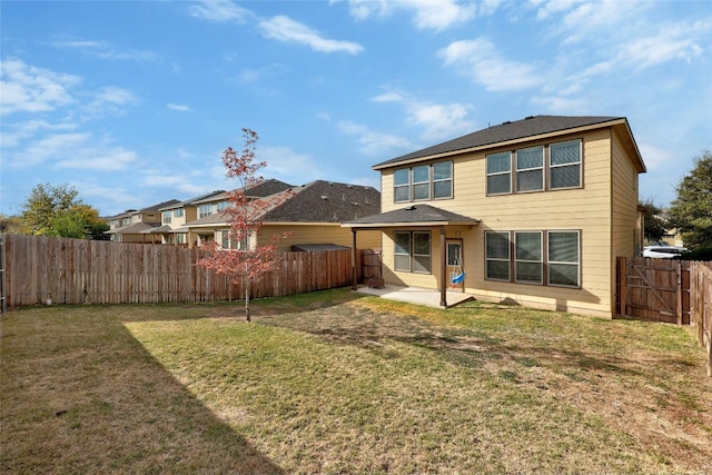 back of property featuring a yard and a patio area