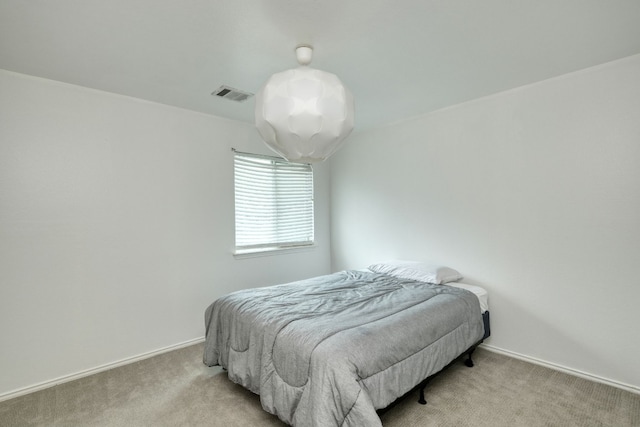 bedroom featuring light carpet