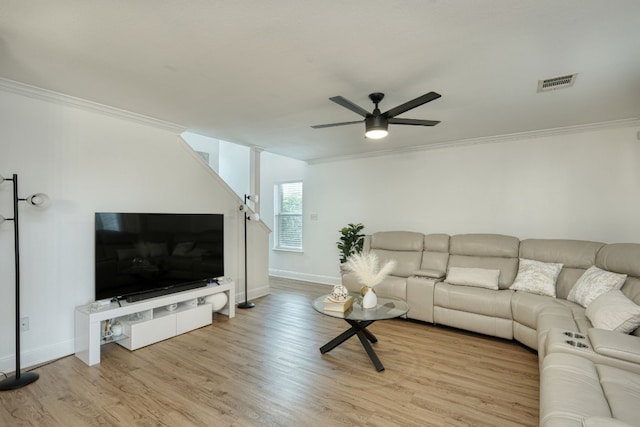 living room with ceiling fan, light wood-type flooring, and ornamental molding