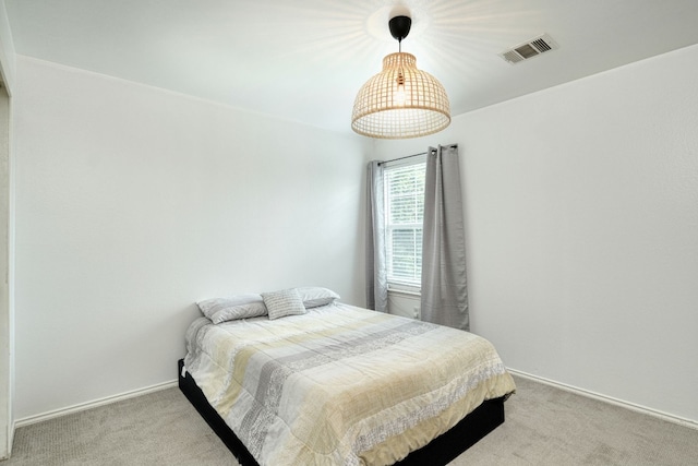 bedroom featuring light carpet