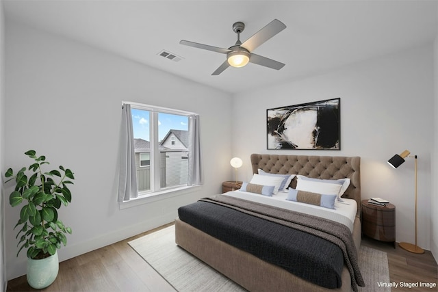 bedroom with ceiling fan and wood-type flooring