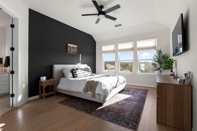 bedroom featuring ceiling fan, lofted ceiling, and light hardwood / wood-style floors