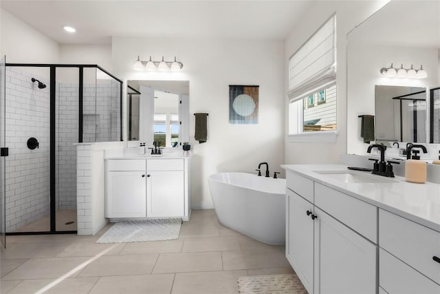 bathroom with independent shower and bath, vanity, and tile patterned floors