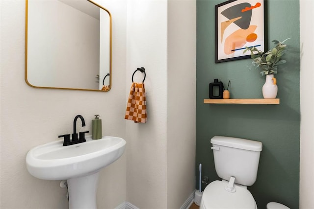 bathroom featuring toilet and sink